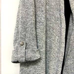 Grey cardigan with attached black under shirt.
